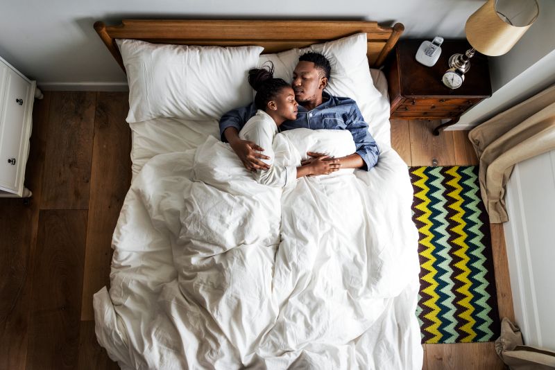 Couple cuddling in bed